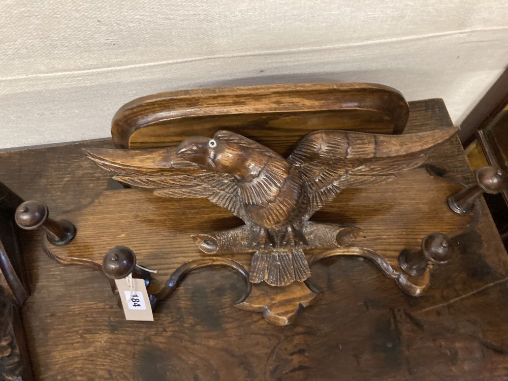 A carved oak eagle hanging coat rack, width 60cm, together with a carved walnut corbel, height 26cm